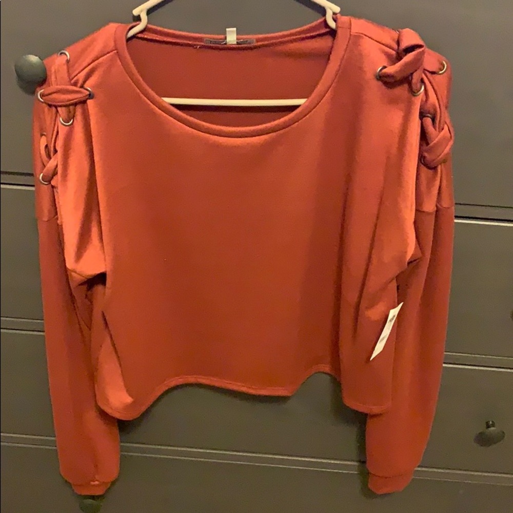 Cropped long sleeve sweater.